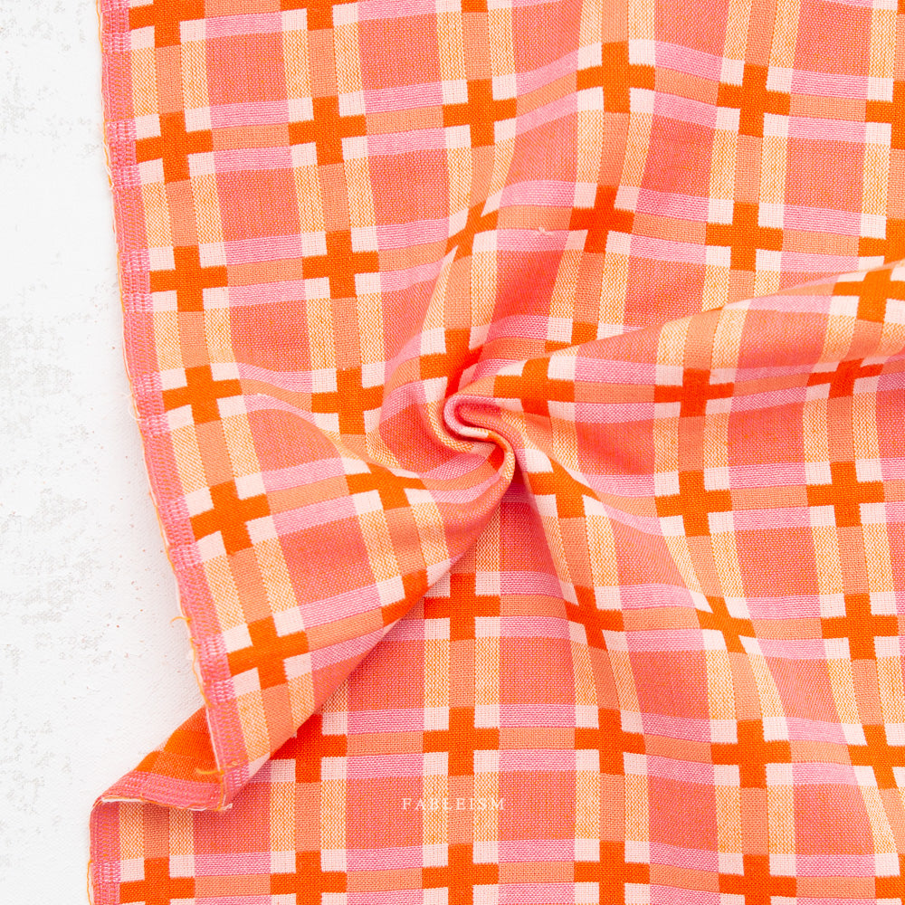 Pink and orange checkered fabric on a white background