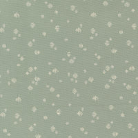 Patterned fabric with small geometric shapes on a green background